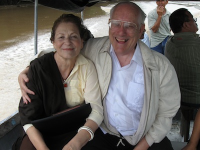 Image of Charles and Judy in boat going through lagoon filled with alligators.